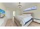 Bright bedroom boasts a tufted headboard, modern lighting, and wood-look flooring at 7327 38Th Court East, Sarasota, FL 34243
