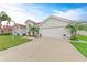 Single-story home with a 2-car garage, lush lawn, and manicured landscaping, offering curb appeal at 7327 38Th Court East, Sarasota, FL 34243