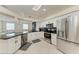 Spacious kitchen featuring stainless steel appliances, granite countertops, and seamless flow into the living area at 7327 38Th Court East, Sarasota, FL 34243