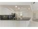 Well-lit kitchen with white cabinets, granite countertops, black backsplash, and stainless steel appliances at 7327 38Th Court East, Sarasota, FL 34243