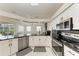 Modern kitchen with granite counters, stainless steel appliances, and an open layout to the living room at 7327 38Th Court East, Sarasota, FL 34243