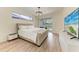 Comfortable main bedroom featuring a plush bed, hardwood floors, and access to an outdoor area at 7327 38Th Court East, Sarasota, FL 34243