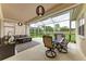 Covered patio has dining and seating areas with views of the backyard and mature landscaping at 7327 38Th Court East, Sarasota, FL 34243