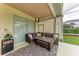 Cozy patio seating area with decorative lighting and view of landscaped backyard at 7327 38Th Court East, Sarasota, FL 34243