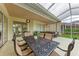 Covered patio includes an outdoor dining area with an outdoor kitchen and garden views at 7327 38Th Court East, Sarasota, FL 34243