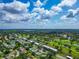 Expansive aerial view of a golf course community with beautiful blue skies and scattered clouds at 7461 W Country Club N Dr # 203, Sarasota, FL 34243