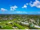 Overhead shot of a community next to a golf course, with houses nestled amongst trees and waterways at 7461 W Country Club N Dr # 203, Sarasota, FL 34243