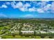 Aerial shot of a residential neighborhood with a golf course, green spaces, and a waterway nearby at 7461 W Country Club N Dr # 203, Sarasota, FL 34243