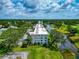 Stunning aerial view of condo by a body of water, surrounded by lush greenery and trees at 7461 W Country Club N Dr # 203, Sarasota, FL 34243