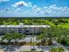 Aerial view of condo with golf course views, lush trees, and convenient parking at 7461 W Country Club N Dr # 203, Sarasota, FL 34243
