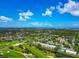 Aerial shot showcasing a golf course neighborhood with interspersed waterways and verdant landscaping at 7461 W Country Club N Dr # 203, Sarasota, FL 34243