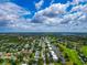 Aerial view of a residential community showcasing lush green landscapes and nearby golf course at 7461 W Country Club N Dr # 203, Sarasota, FL 34243