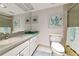 Bathroom featuring a vanity, mirror, updated sink, and charming seaside art at 7461 W Country Club N Dr # 203, Sarasota, FL 34243