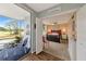 Spacious bedroom connects to screened-in porch with golf course views, creating a tranquil living space at 7461 W Country Club N Dr # 203, Sarasota, FL 34243