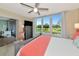 The bedroom has a large window with golf course views and a gray dresser for storage at 7461 W Country Club N Dr # 203, Sarasota, FL 34243