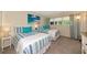 Bright bedroom featuring two beds, coastal decor, and a sunny window at 7461 W Country Club N Dr # 203, Sarasota, FL 34243