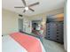 Bright bedroom with golf course views, a large dresser, and access to an additional living area at 7461 W Country Club N Dr # 203, Sarasota, FL 34243