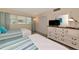 Bright bedroom with two beds, large dresser, and sunny window views at 7461 W Country Club N Dr # 203, Sarasota, FL 34243