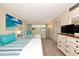 Comfortable bedroom with two beds, dresser, closet, and bright windows at 7461 W Country Club N Dr # 203, Sarasota, FL 34243