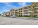 Exterior of a condo building showcasing balconies, landscaped grounds, parking, and a well-maintained facade at 7461 W Country Club N Dr # 203, Sarasota, FL 34243