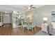 Cozy dining area with a round table, seating for four, and a view into the bright living space at 7461 W Country Club N Dr # 203, Sarasota, FL 34243