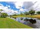 Beautiful exterior featuring a lake view with lush landscaping at 7461 W Country Club N Dr # 203, Sarasota, FL 34243