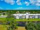 Waterfront condo building featuring balconies, and surrounded by lush landscaping, and tranquil water views at 7461 W Country Club N Dr # 203, Sarasota, FL 34243