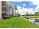 Exterior of the home with a lake view and well maintained landscaping at 7461 W Country Club N Dr # 203, Sarasota, FL 34243