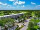 Condo building featuring a canopy, well-maintained landscaping, and parking, near a well-manicured golf course at 7461 W Country Club N Dr # 203, Sarasota, FL 34243