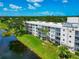 Exterior view of a residential complex, showcasing multiple balconies and manicured grounds at 7461 W Country Club N Dr # 203, Sarasota, FL 34243