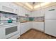 Well-lit kitchen featuring white appliances, ample counter space, and a stylish backsplash at 7461 W Country Club N Dr # 203, Sarasota, FL 34243