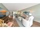Open-concept living area with a view of the dining space, comfortable seating, and bright natural light at 7461 W Country Club N Dr # 203, Sarasota, FL 34243