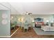 Cozy living and dining area with stylish decor, a large mirror, and plenty of natural light at 7461 W Country Club N Dr # 203, Sarasota, FL 34243