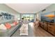 Bright living room with a comfortable seating area, sliding doors to a patio and a modern TV console at 7461 W Country Club N Dr # 203, Sarasota, FL 34243