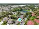 Panoramic aerial view showcasing a peaceful community with a pool, lush greenery, and scenic pond at 7926 Woodpointe Ct # 29, Sarasota, FL 34238