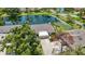 Aerial view of the property showcasing the house, serene pond, lush greenery, and surrounding neighborhood at 7926 Woodpointe Ct # 29, Sarasota, FL 34238