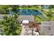 Aerial view of the property showing the house, pond, lush greenery, and surrounding neighborhood at 7926 Woodpointe Ct # 29, Sarasota, FL 34238