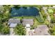 Stunning aerial view of the property backing onto a serene pond with lush landscaping and mature trees at 7926 Woodpointe Ct # 29, Sarasota, FL 34238