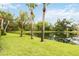 Green lawn leading to a tranquil pond, enhanced by trees and landscaping, in a serene community setting at 7926 Woodpointe Ct # 29, Sarasota, FL 34238