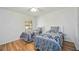 A bright bedroom with two twin beds, ceiling fan and wood look flooring at 7926 Woodpointe Ct # 29, Sarasota, FL 34238