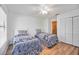 Bright bedroom featuring two twin beds, a ceiling fan and a closet at 7926 Woodpointe Ct # 29, Sarasota, FL 34238