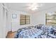 Bedroom featuring two twin beds, wood look flooring, and an included dresser at 7926 Woodpointe Ct # 29, Sarasota, FL 34238