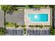 Aerial view of a community pool with brick patio, sun loungers, and ample parking available at 7926 Woodpointe Ct # 29, Sarasota, FL 34238