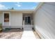 Inviting entryway exterior featuring new concrete sidewalk, steps, and new paint at 7926 Woodpointe Ct # 29, Sarasota, FL 34238