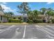 Well-maintained home exterior featuring manicured landscaping, assigned parking, and a welcoming entrance at 7926 Woodpointe Ct # 29, Sarasota, FL 34238