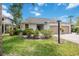 Inviting home with an attached garage, professional landscaping with flowering shrubs, and a green lawn at 7926 Woodpointe Ct # 29, Sarasota, FL 34238
