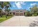 Inviting villa-style home with a private driveway and attached garage, framed by lush tropical landscaping at 7926 Woodpointe Ct # 29, Sarasota, FL 34238