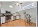 Efficient kitchen with stainless appliances, breakfast bar seating, and bright, airy ambiance at 7926 Woodpointe Ct # 29, Sarasota, FL 34238