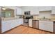 A well-lit kitchen featuring stainless steel appliances and white cabinetry at 7926 Woodpointe Ct # 29, Sarasota, FL 34238