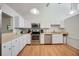 Bright kitchen with white cabinets, stainless steel appliances, and practical layout at 7926 Woodpointe Ct # 29, Sarasota, FL 34238
